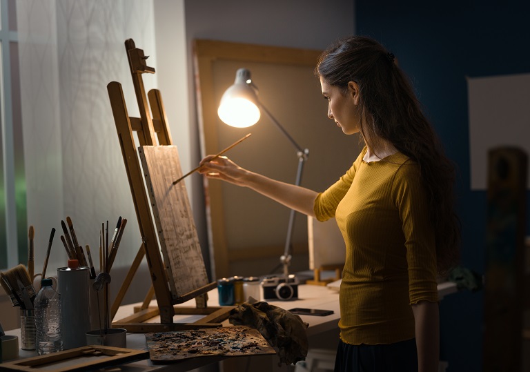 woman painting with oil paints