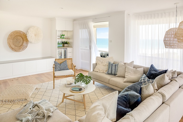 living room designed in coastal style with neutral and blue colours