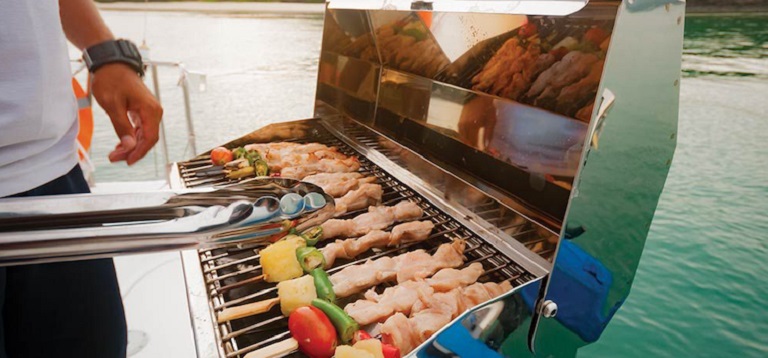 man doing barbeque on the boat