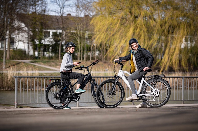 man and woman on long-distance e-bikes